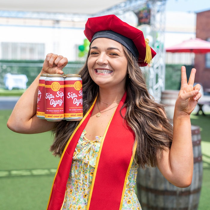 Woman posing with graduation-themed 4-pack custom label